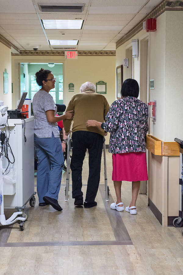 Nursing staff assisting with ambulation, walking with a walker, compassion, teamwork, 60 West Rocky Hill